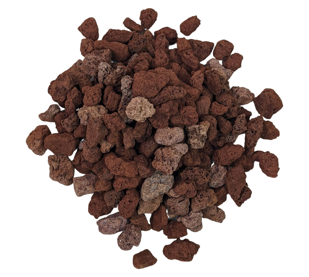 Against a white background, Black Rock Grills Horticultural Lava Rocks form a mound of reddish-brown, porous volcanic rocks. These 1-2cm rough-textured stones vary in size and shape, enhancing water retention and making them perfect for hydroponic culture. Available in 20kg bags.