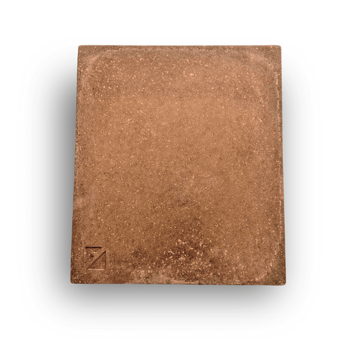 The Effeuno Biscotto Clay Pizza Stone is a square, textured brown stone resembling a brick or tile. It features an embossed Z in the bottom left corner and is made from claystone to achieve an authentic Neapolitan pizza finish, set against a crisp white background.