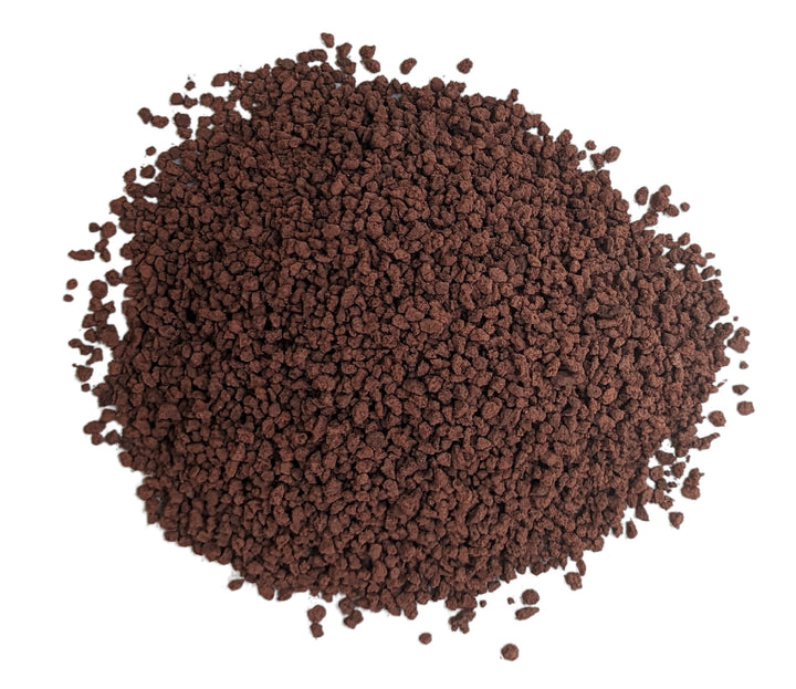 A collection of coarse Horticulture Aquascaping Lava Rocks by Black Rock Grill, sized 2-10mm and weighing 1KG, on a white background resembles dark brown instant coffee granules, perfect for creating textured underwater landscapes.