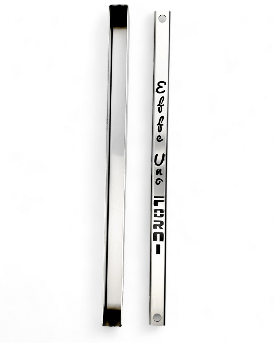 Two vertical rectangular nameplates, one flat and one angled, rest on a white background. The flat plate has Effeuno and LIONS engraved in stylized fonts, reminiscent of the meticulous design seen in an Effeuno Steamer for baking Bread that enhances the baking experience.