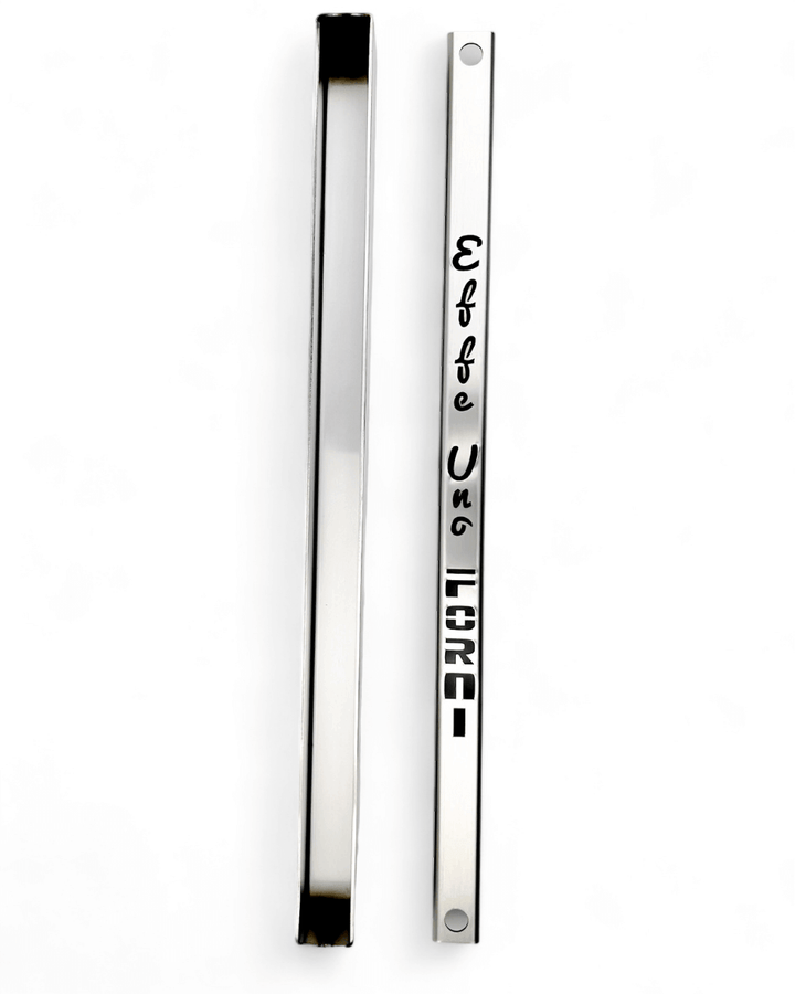 Two vertical rectangular nameplates, one flat and one angled, rest on a white background. The flat plate has Effeuno and LIONS engraved in stylized fonts, reminiscent of the meticulous design seen in an Effeuno Steamer for baking Bread that enhances the baking experience.
