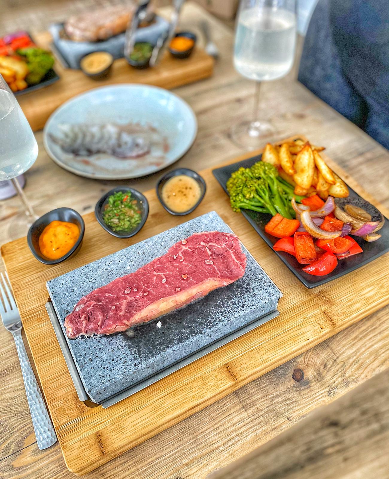 steak cooking on the hot rock