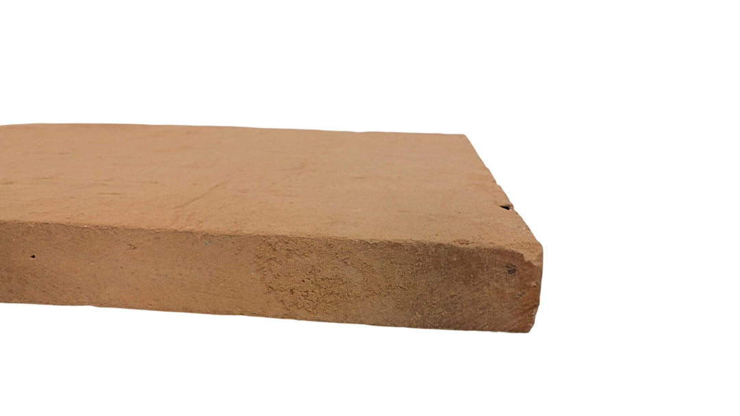 A close-up of the Effeuno Naples Small Biscotto Clay Pizza Stone (32x32x2cm), rectangular and brown with a rough texture, designed for high-heat Neapolitan pizza ovens, compliant and shown on a white background.