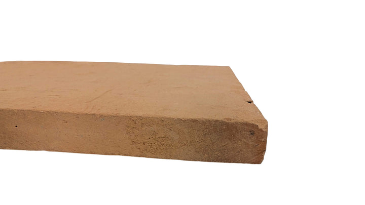 A close-up of the Effeuno Naples Small Biscotto Clay Pizza Stone (32x32x2cm), rectangular and brown with a rough texture, designed for high-heat Neapolitan pizza ovens, compliant and shown on a white background.