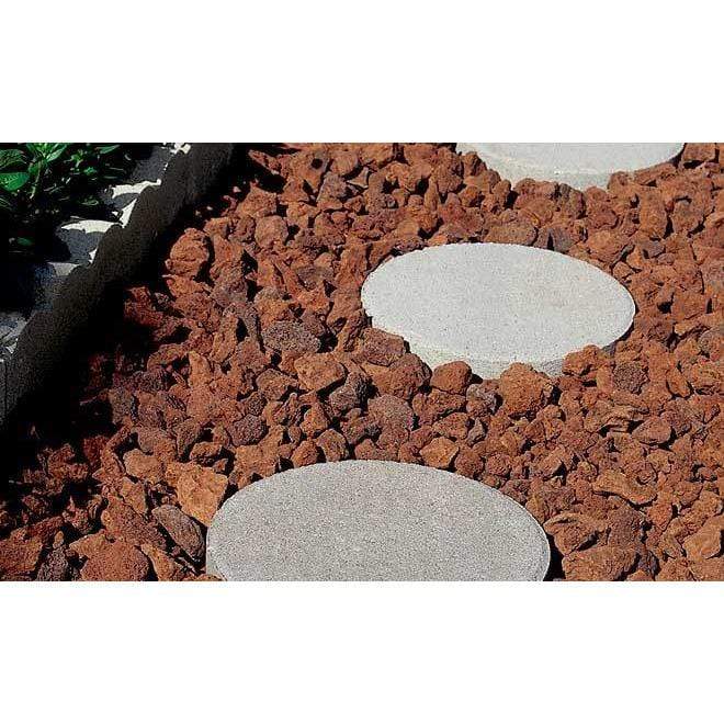 Black Rock Grill Lava Rocks for garden laid on the ground with stepping stones in between