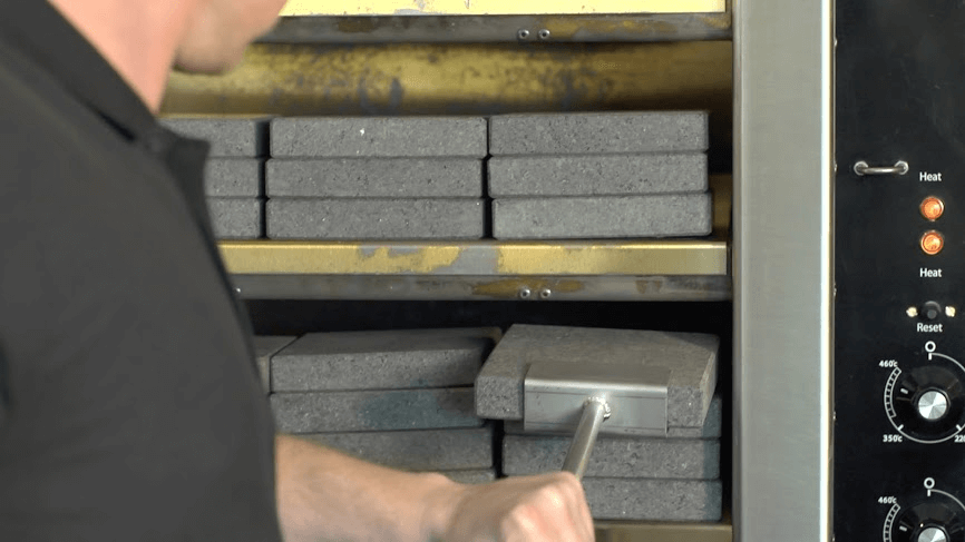 BR108 Rock oven showing door open with rocks stacked inside