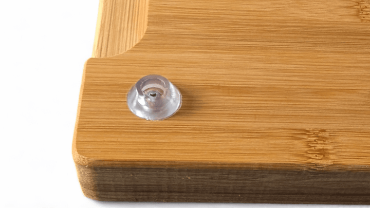 foot on wooden serving chopping board