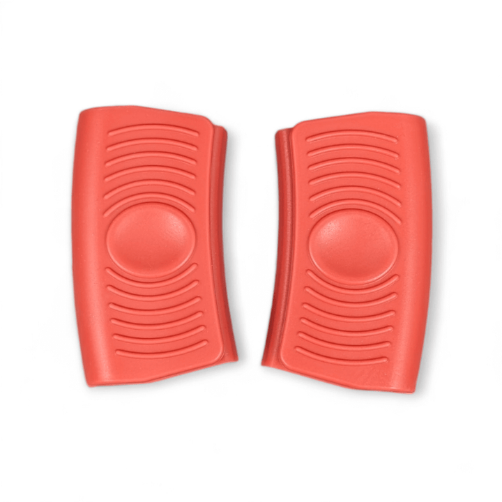A pair of Black Rock Grill Silicone Heat Resistant Handle Holder Covers—premium food-grade heat protectors for hot handles—feature red, curved designs with textured wave-like patterns and raised circular centers, shown side by side on a white background.