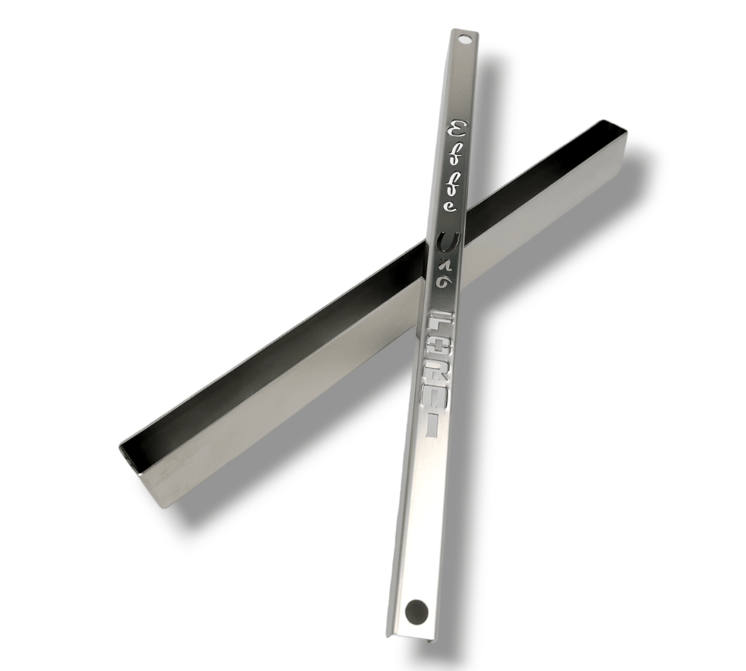 Two sleek metallic tools in an X shape, each engraved. The top tool resembles an Effeuno Steamer for baking Bread with a detailed design; the bottom is plain. Both have small holes near one end for precise moisture control during your baking experience.
