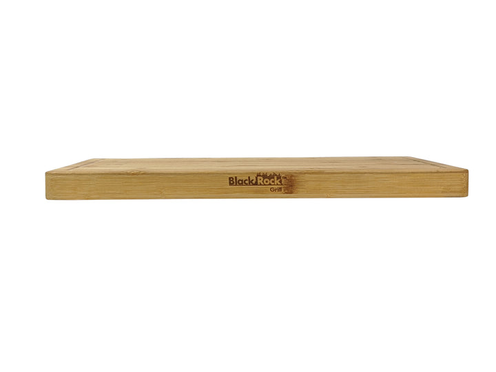 The large wooden serving board by Black Rock Grill, measuring 44cm x 27cm x 3cm, features rounded edges and an engraved logo. Made from sustainable bamboo, it has a smooth surface and elegant light brown finish. The image on a white background highlights its eco-friendly craftsmanship.