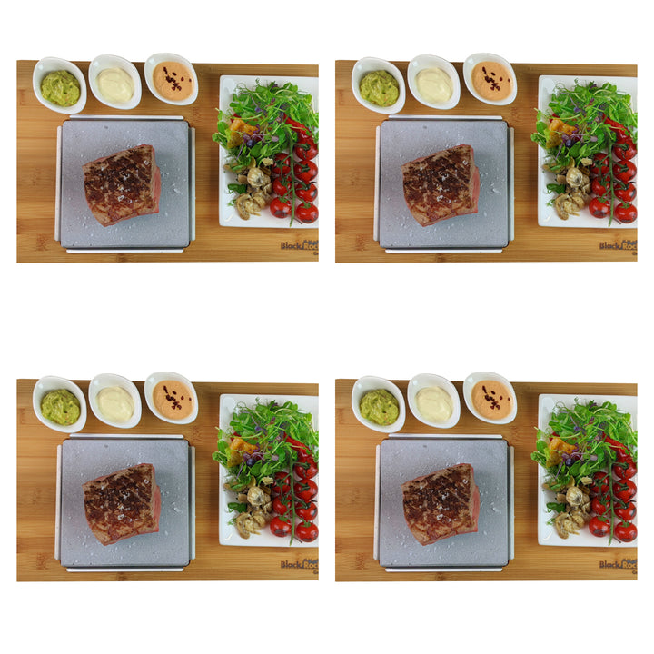 Four identical images showcase the Black Rock Grill Steak On The Stone Set featuring a seasoned raw steak on a cutting board with small bowls of sauces. A plate of mixed greens, cherry tomatoes, and roasted vegetables is neatly arranged on a wooden surface, ideal for hot stone dining.