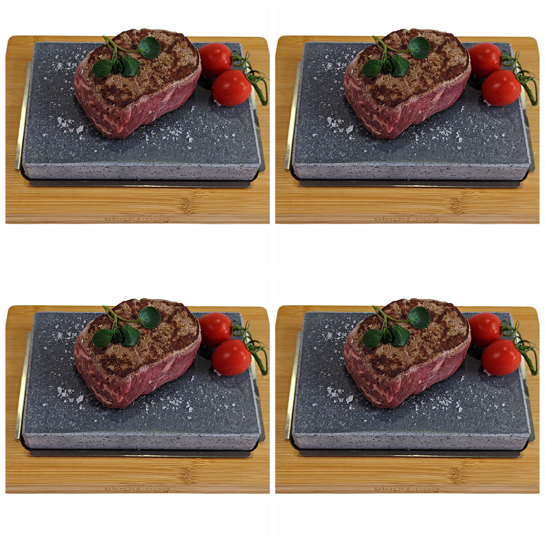 Four identical images of raw steak on a dark stone slab, garnished with herbs and cherry tomatoes on wood, showcase the essence of healthy dining—an ideal culinary adventure with the Black Rock Grill Steak Stone Cooking Set.