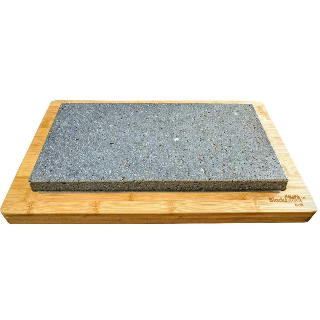 A rectangular grey stone slab, called the Sharing Stone replacement- ROK-37, rests on a wooden board with smooth edges. Part of the sleek Grill Set by Black Rock Grill, it has a rough texture suitable for grilling or serving. The brand name is engraved in one corner.