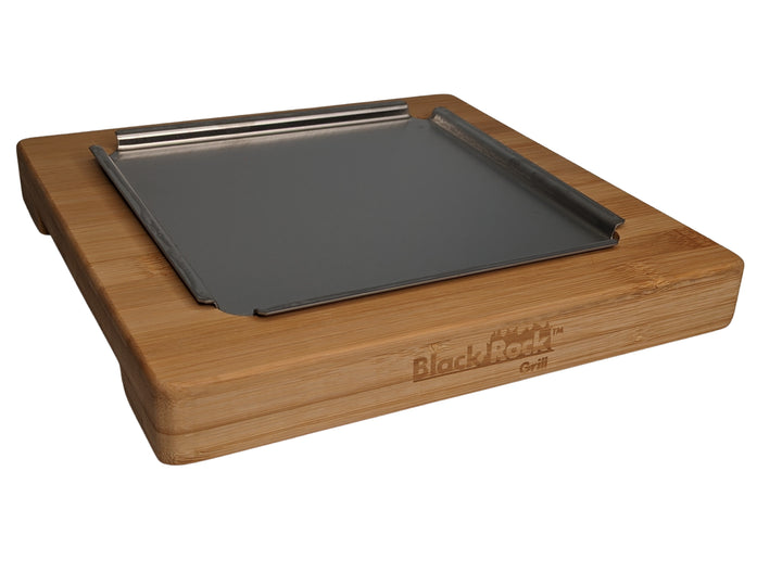 The NEW Black Rock Grill Lava Stone Steak Multi Pack includes a rectangular bamboo platter with an elevated inset metal tray. Perfect for hot stone cooking or serving, it combines stylish and functional design under the trusted Black Rock Grill brand.