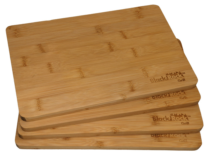 Four sustainable bamboo cutting boards are neatly stacked, each featuring Black Rock Grill laser engraved in one corner.