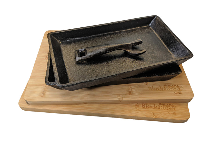 The Black Rock Grill Fajita Cast Iron Skillet Set includes 12 lead-free pieces: rectangular sizzler pans, a metal tool, and engraved bamboo boards. Enjoy durable, stylish cookware perfect for your kitchen.