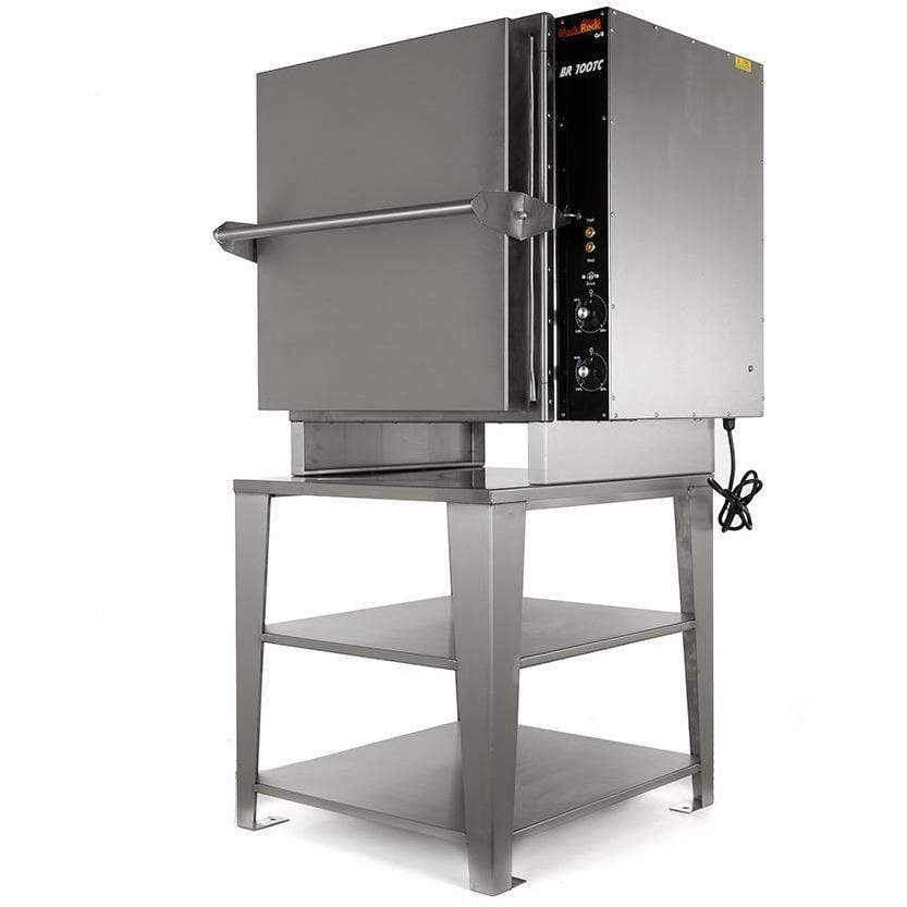The Black Rock Grill BR108 includes a cubic, metallic rock oven ideal for live demos, sitting on a sturdy two-shelf metal stand. It has right-side control knobs and a visible power cord.
