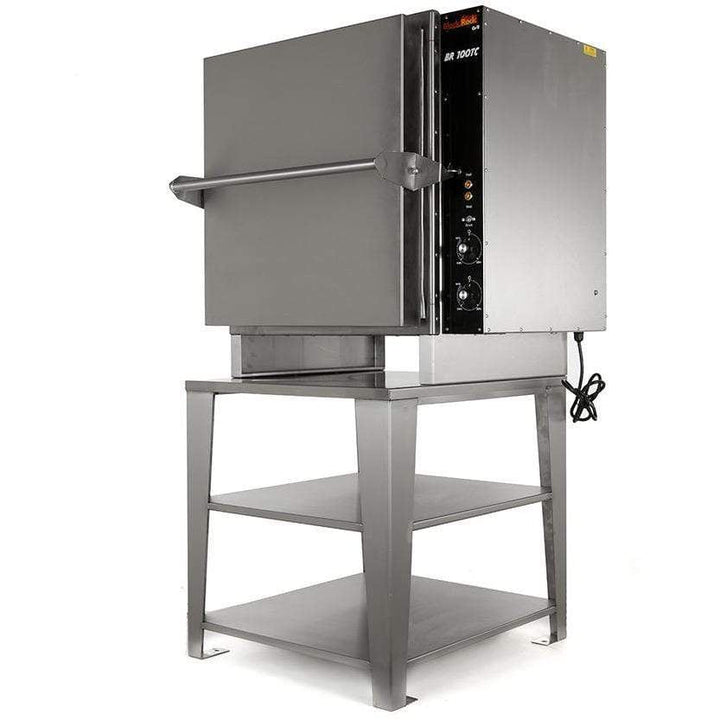 The Black Rock Grill BR108 includes a cubic, metallic rock oven ideal for live demos, sitting on a sturdy two-shelf metal stand. It has right-side control knobs and a visible power cord.