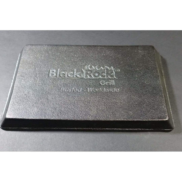 A rectangular black cast iron skillet from Black Rock Grill’s 12-piece Fajita Set features "Black Rock Grill" and "Trusted Worldwide" engraving, displayed against a dark background.