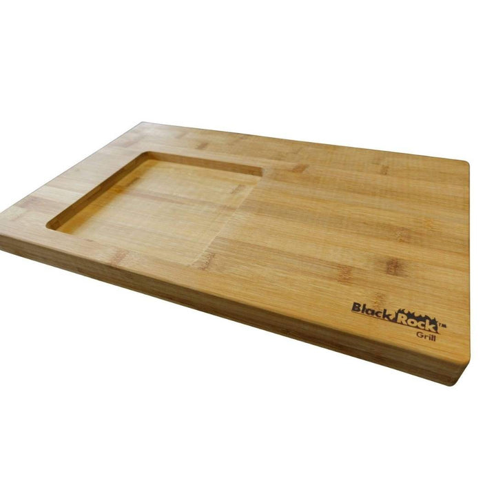 The GP-6 Bamboo board set by Black Rock Grill features a rectangular cutting board with an engraved logo in the lower right corner, a recessed square section for steak on the stone sets, and a smooth, light brown finish adding sophistication to your kitchen.