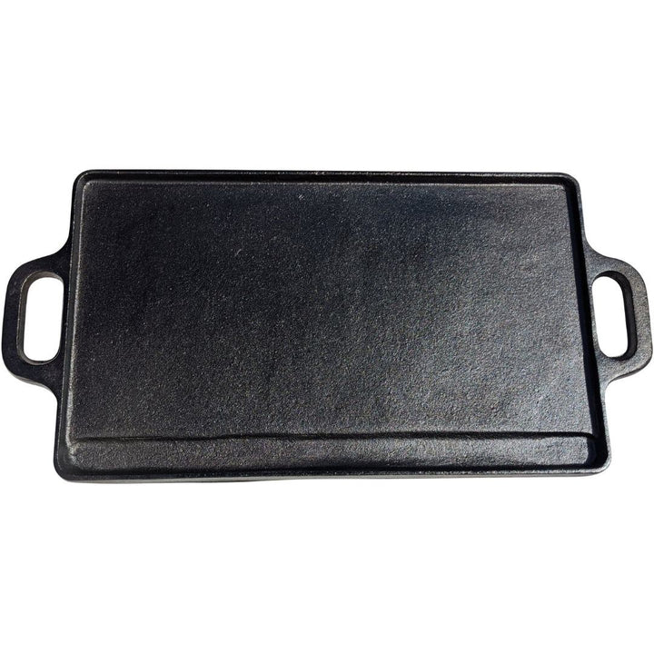 The Black Rock Grill Large Reversible Cast Iron Griddle Pan, 46cm x 23cm with silicone grip handles, is shown from above on a white background. Ideal for BBQs and compatible with gas, electric hob, and ovens. Includes oil brush.