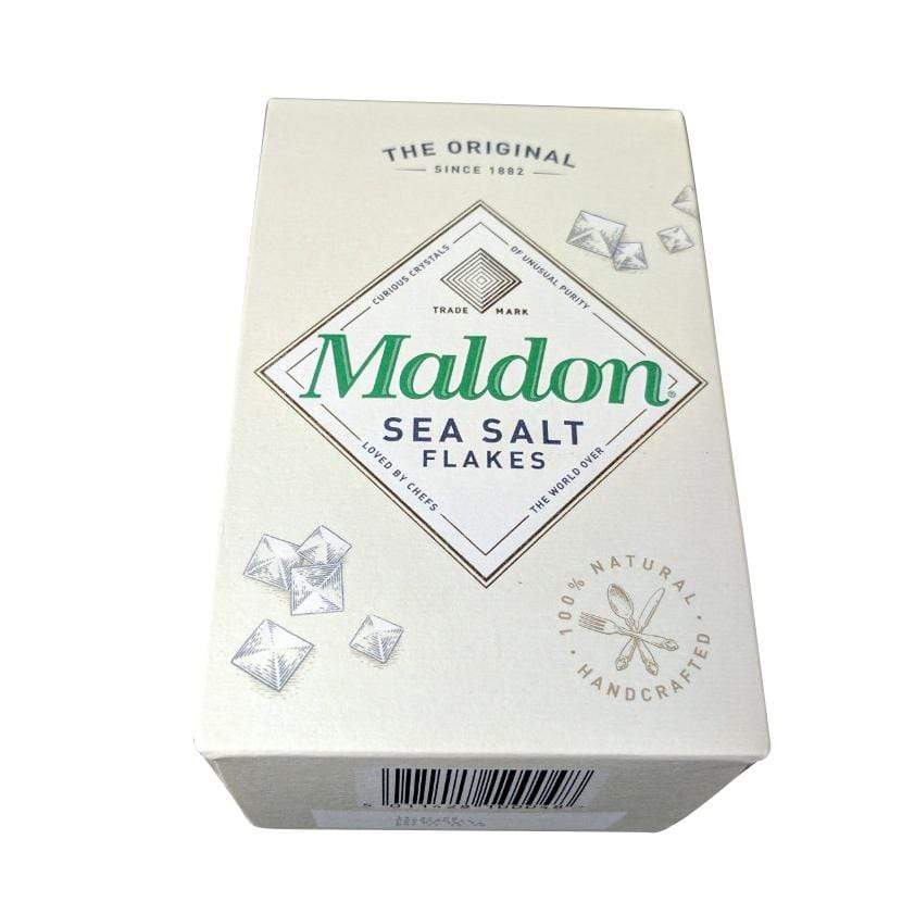 A box of Black Rock Grills Maldon Sea Salt Flakes features its iconic finishing salt. The cream packaging with green and black text includes diamond shapes like the flakes, highlighting The Original and 100% Natural Handcrafted since 1882.
