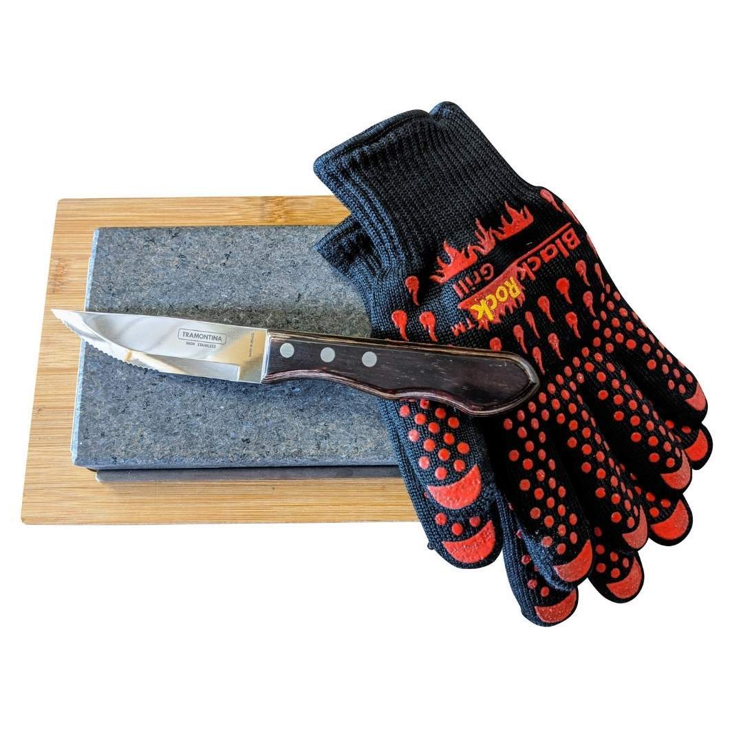 The Black Rock Grill Hot Steak Stones Cooking Gift Set by Black Rock Grill includes a wooden-handled knife, black and red heat-resistant gloves, and a sharpening stone—essential tools for an exceptional steak stone experience.