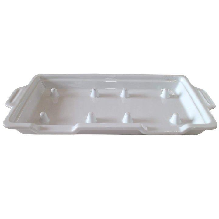 The GP-3 White Porcelain Double Rock Platters by Black Rock Grill are white ceramic rectangular baking dishes with side handles and cone-shaped spikes on a glossy surface, ideal for supporting food during cooking, available in a case of 6.