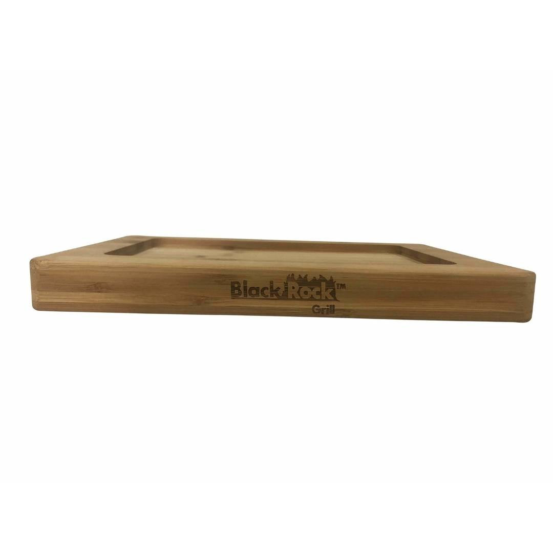 The Black Rock Grill logo enhances the GP-28 Bamboo Board, made from sustainable bamboo with rounded edges and a recessed surface. Seen from a low angle on a white background, it merges style and functionality. Comes in cases of 12 for the Hot Steak Stones Cooking Rock Set.