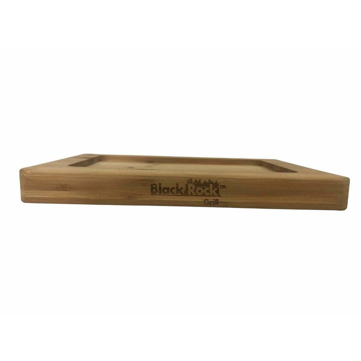 The Black Rock Grill logo enhances the GP-28 Bamboo Board, made from sustainable bamboo with rounded edges and a recessed surface. Seen from a low angle on a white background, it merges style and functionality. Comes in cases of 12 for the Hot Steak Stones Cooking Rock Set.
