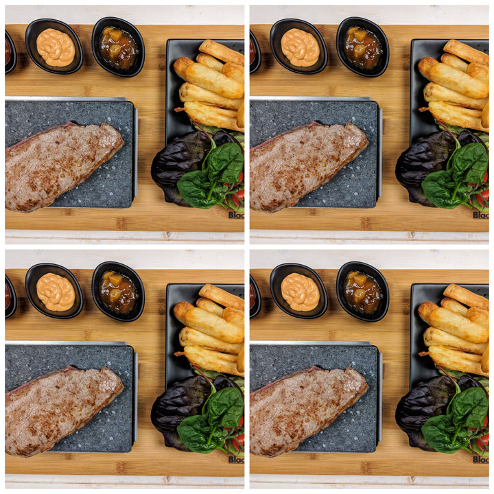 A collage of four identical images showcases the Black Rock Grill Matt Black Steak Stones Cooking Set sizzling with sides of wedges, orange sauce, and a small bowl of relish. Garnished with green and purple leaves, this healthy dining experience is artfully presented on a wooden board.