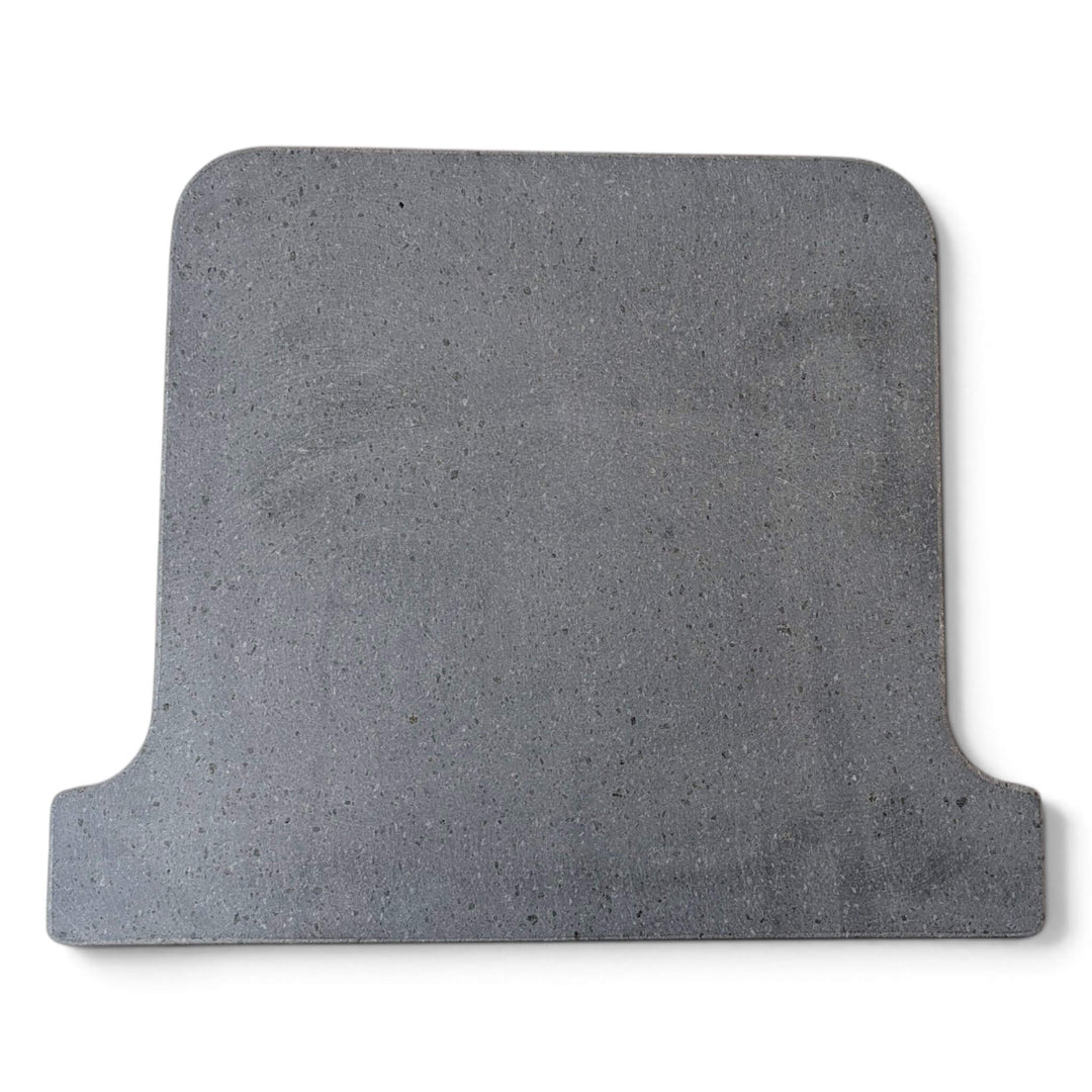 Top view of a grey Lava pizza oven stone that fits the ooni koda 16 pizza oven square with rounded corners and a stepped, notched edge on one side, shown on a plain white background.