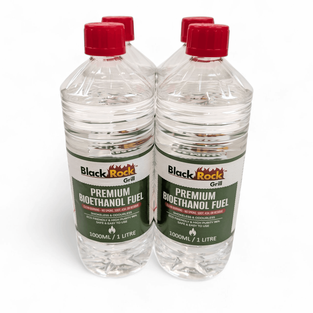 Four 1L bottles of Black Rock Grill Premium Bioethanol Fuel are shown together on a white background. Each green-labeled bottle contains clean-burning, plant-based liquid suitable for fireplaces, fire pits, and stoves.