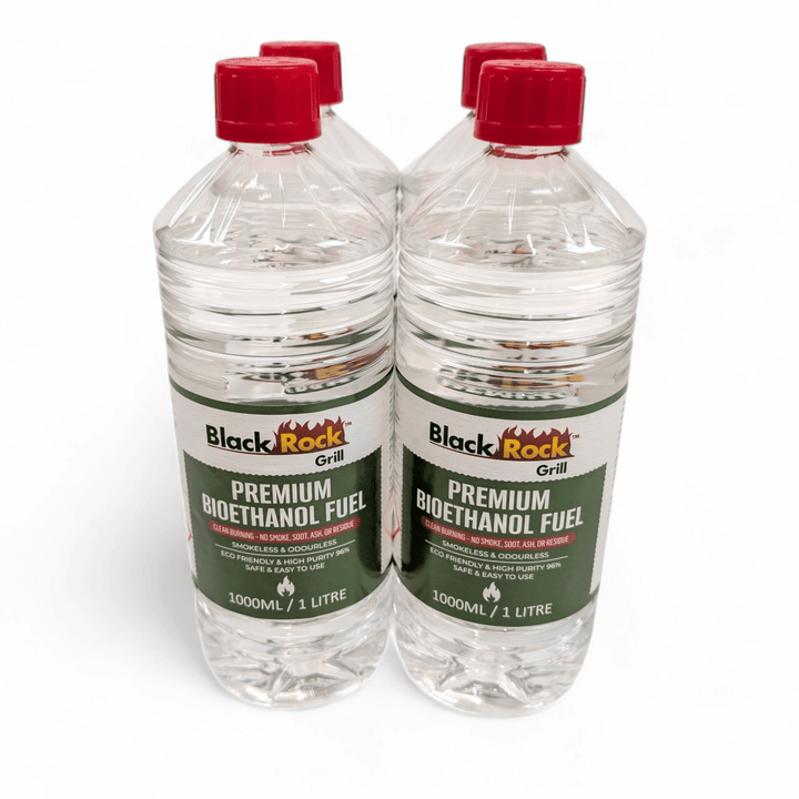 Four 1L bottles of Black Rock Grill Premium Bioethanol Fuel are shown together on a white background. Each green-labeled bottle contains clean-burning, plant-based liquid suitable for fireplaces, fire pits, and stoves.