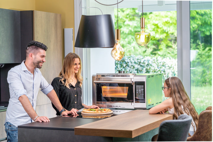 people eating pizza by the p134ge pizza oven