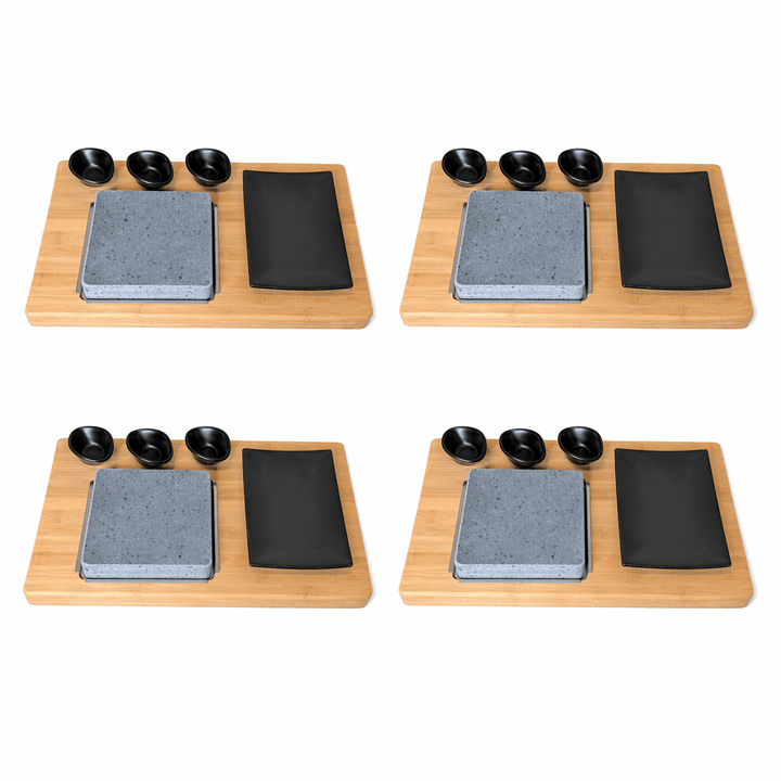 Set of four Black Rock Grill HO-09PMB steak stones with bamboo boards matt black porcelain side plates and dipping pots on a white background