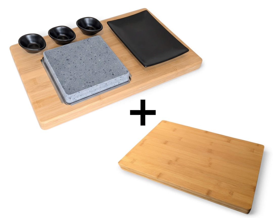 Lava stone cooking set with matt black dipping pots and side plate on a bamboo board with a + sign and a stand alone bamboo board