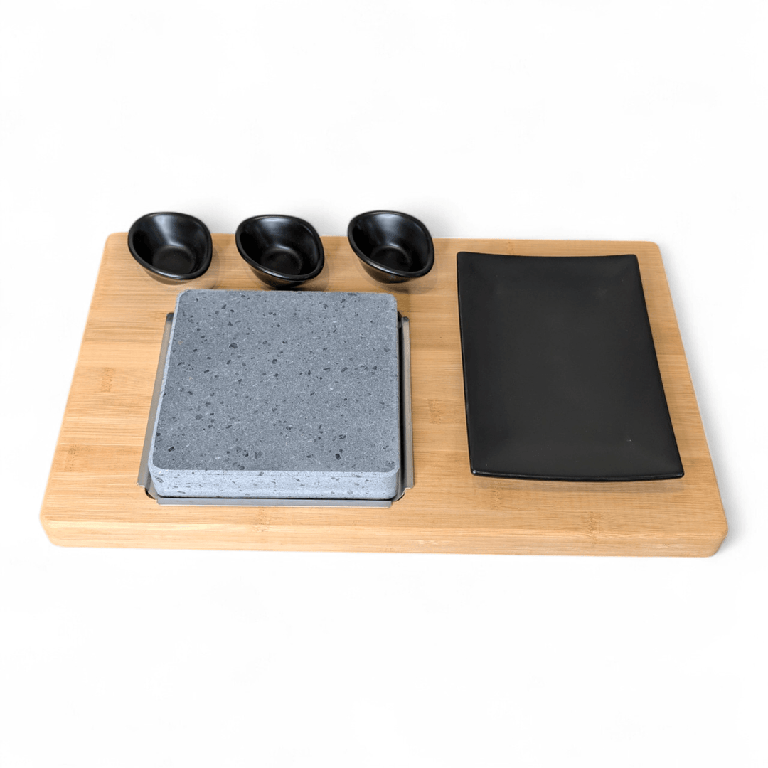 HO-09PMB steak stone on a bamboo platter with matt black porceline side plate and three dipping pots cooking set displayed on a white background