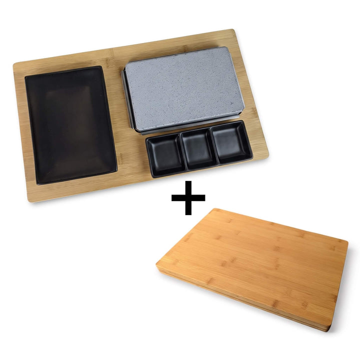 Featuring the Black Rock Grill Black Steak Stone Cooking Set, this bundle includes a sleek bamboo serving tray with a gray stone slab, three small black dishes, one large black dish, and a FREE £19.99 plain bamboo cutting board (indicated by a plus sign below). Perfect for an authentic hot stone cooking experience at home.