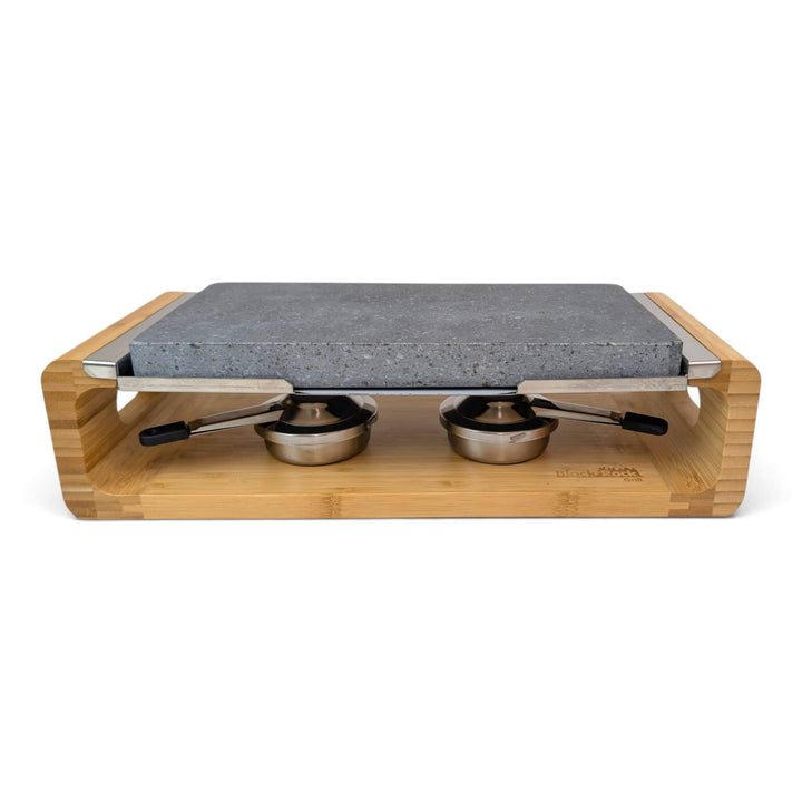 A bamboo-framed tabletop hot lava stone cooking set stove with two stainless steel gel burners to keep the stone hot for longer, photographed on a clean white background.