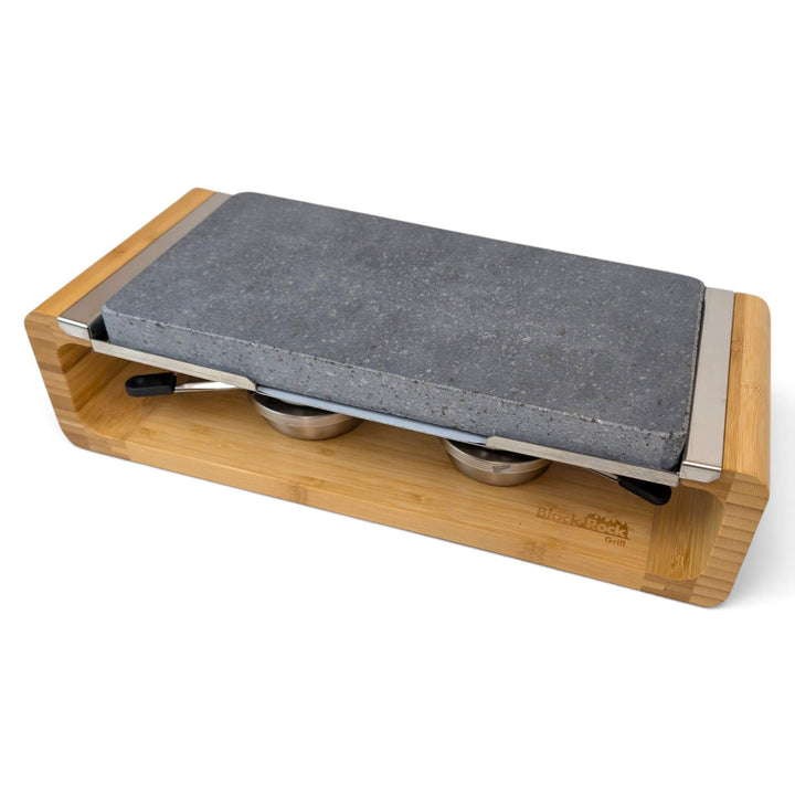 A bamboo-framed tabletop hot lava stone cooking set stove with two stainless steel gel burners to keep the stone hot for longer, photographed on a clean white background.
