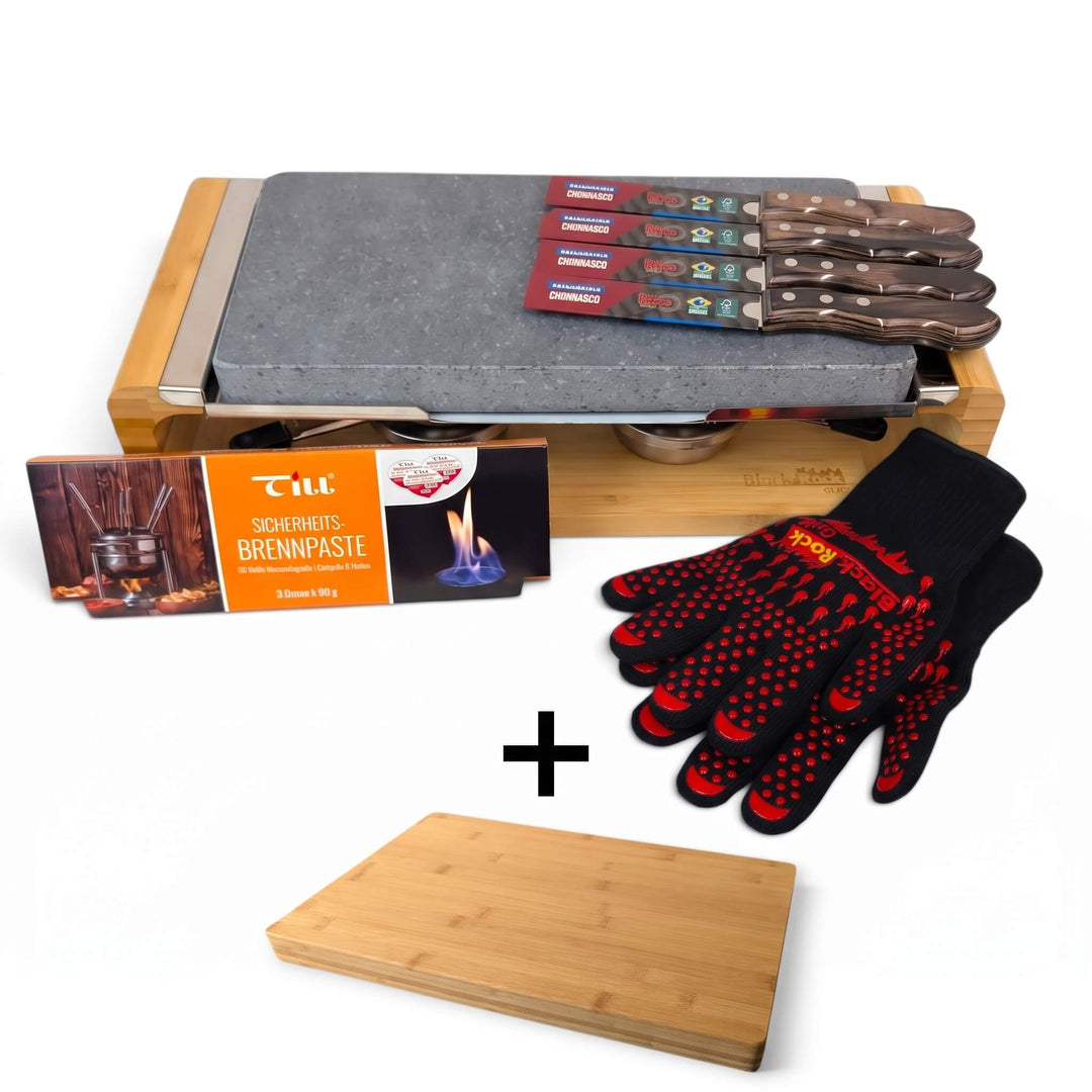 Introducing the Black Rock Grill Steak Stone Sharing Platter & Grill Set by Black Rock Grill, featuring a premium lava rock grill, four steak knives, a box of fuel paste, a pair of black heat-resistant gloves with striking red accents, and an additional FREE bamboo board (worth £19.99) displayed beneath the tabletop grill.