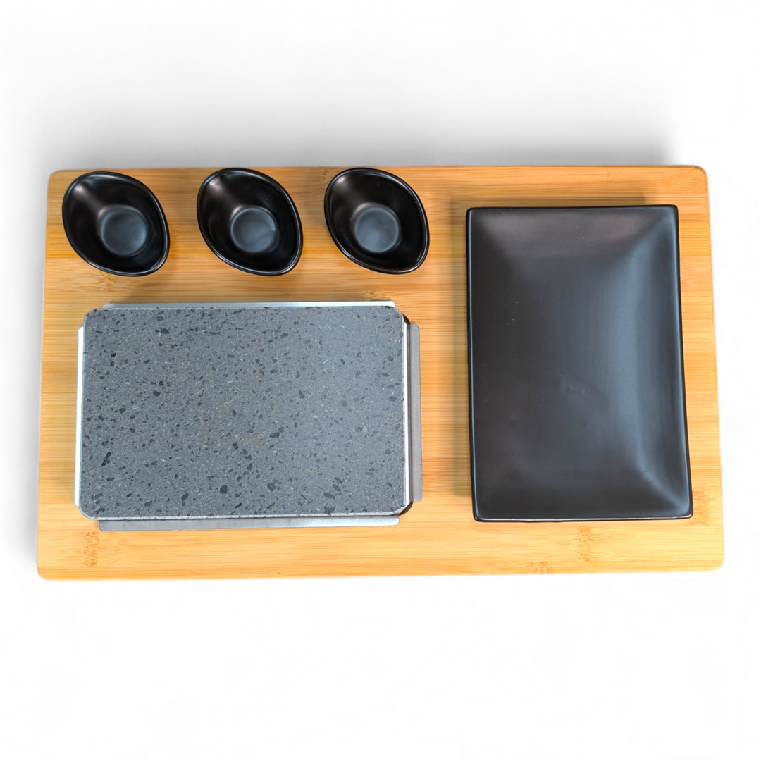 Elevate your steak stone dining experience with the Black Rock Grill Replacement Bamboo Boards for Steak Stone Cooking Set (Case of 6), featuring a sturdy rectangular wooden board topped with a stone slab, a spacious black rectangular plate, and three small black oval dishes—all perfectly arranged for stylish serving or as ideal replacements for your Black Rock Grill set.
