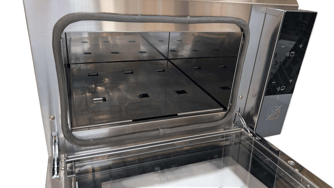 A close-up of the ROXY12 | 12 Rock, 12 Plate, Rock Oven & Accessories Set Up by Black Rock Grill, featuring a stainless steel build with glass window, right-side control panel, and grid-like interior for healthy dining experiences.