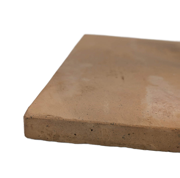 A close-up of the Effeuno XL Biscotto Clay Pizza Stone (50x50x2cm), handmade in Naples and Neapolitan compliant, showing its light brown, slightly rough surface—ideal for baking authentic pizzas against a white background.