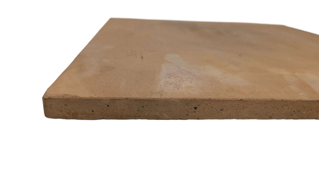 A close-up of the Effeuno XL Biscotto Clay Pizza Stone (50x50x2cm), handmade in Naples and Neapolitan compliant, highlights its rectangular edge—perfect for baking authentic pizza.