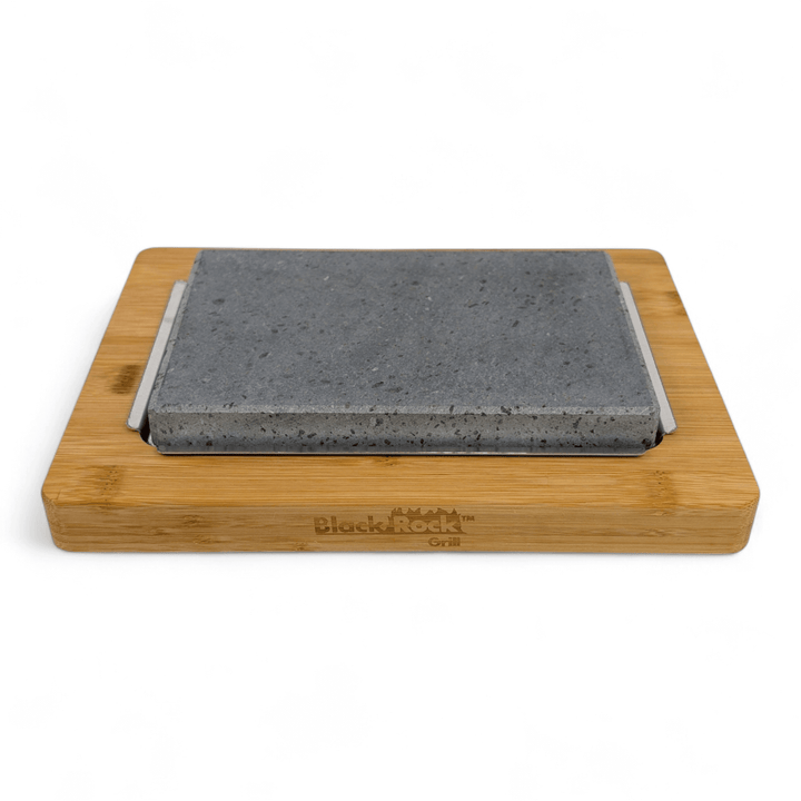 The Lava Sizzler Finishing Warming Platter by Black Rock Grill features a rectangular gray stone on a wooden tray engraved with the brand name, offering versatile tabletop cooking or serving against a plain white background.
