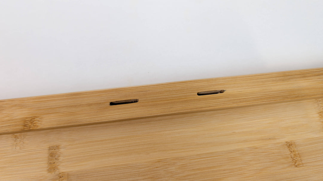 A close-up of the Black Rock Grill Large Lava Sizzler Finishing Warming Platter, featuring a light wooden base with two rectangular slots on a raised edge for holding a natural lava stone, shown against a plain white background.