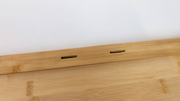 A close-up of the Black Rock Grill Large Lava Sizzler Finishing Warming Platter, featuring a light wooden base with two rectangular slots on a raised edge for holding a natural lava stone, shown against a plain white background.