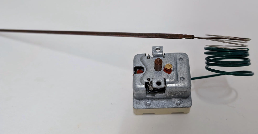 The Black Rock Grill Effeuno 515°C Overheat Reset Switch for P134H/P134HA (450°C, 500°C, 509°C) features a long probe, coiled green wire, adjustment screws, and red indicator. Often used in Effeuno ovens. Plain white background shown.